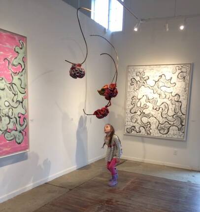 Picture of kid looking at art in MAC gallery